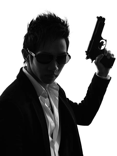 istock asian gunman killer portrait silhouette 488875485