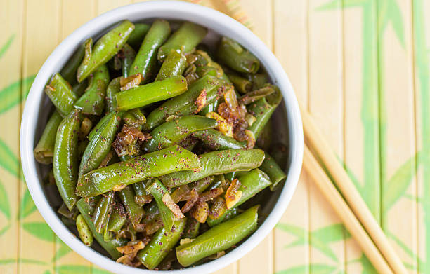 istock Green beans with garlic, onion and red pepper. Warm salad 488878404