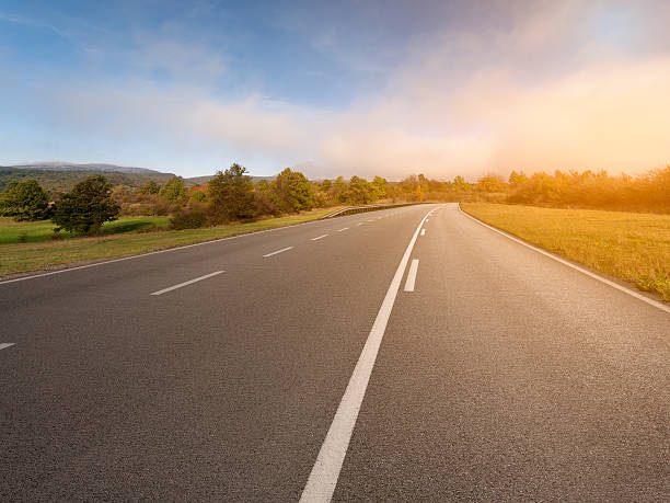 istock Driving on an empty asphalt road at autumn 488882264