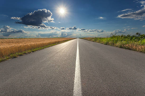 istock Driving on an empty asphalt road at sunset 488882620