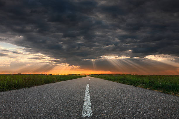 istock Driving on an empty asphalt road towards the sunbeams 488882690