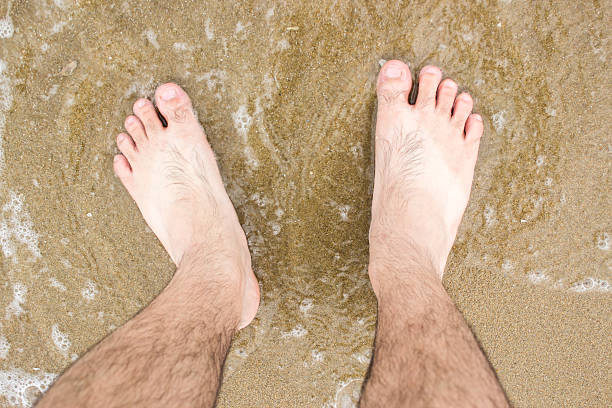 istock barefoot in sea with foam 488884580