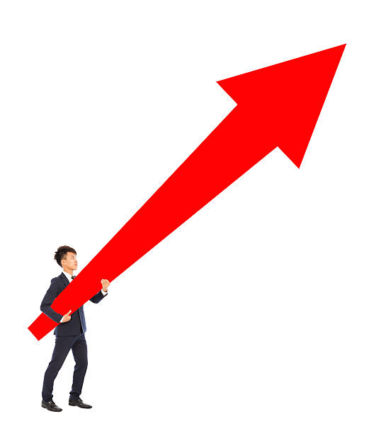 istock businessman standing and holding a upward red arrow 488889447