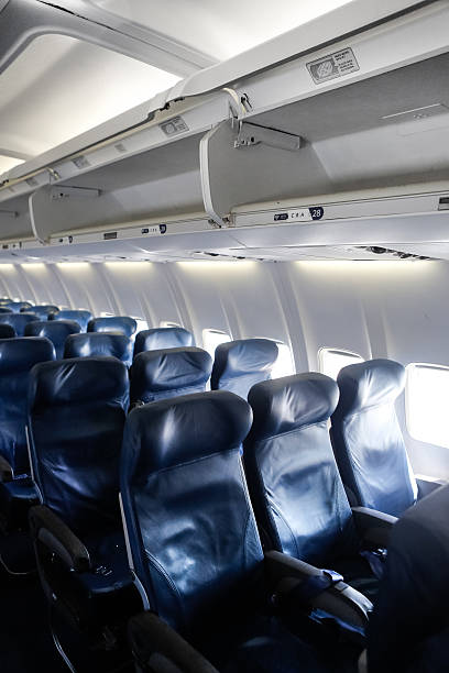 istock Airline Coach Cabin with Overhead Baggage Compartments 488889633