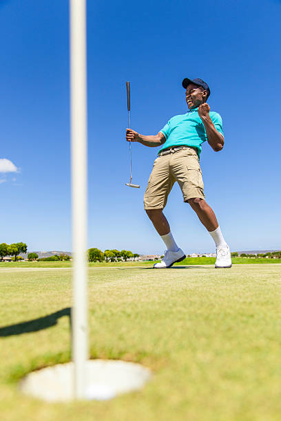 African golfer celebrating sinking his putt!