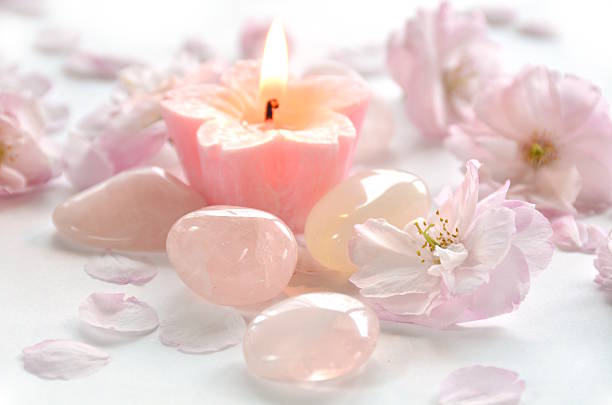 candle with cherry blossoms and gemstones stock photo