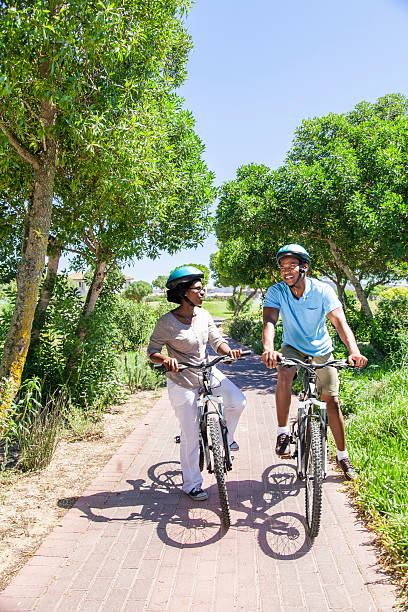 istock African couple cycling through a golf course 488891359