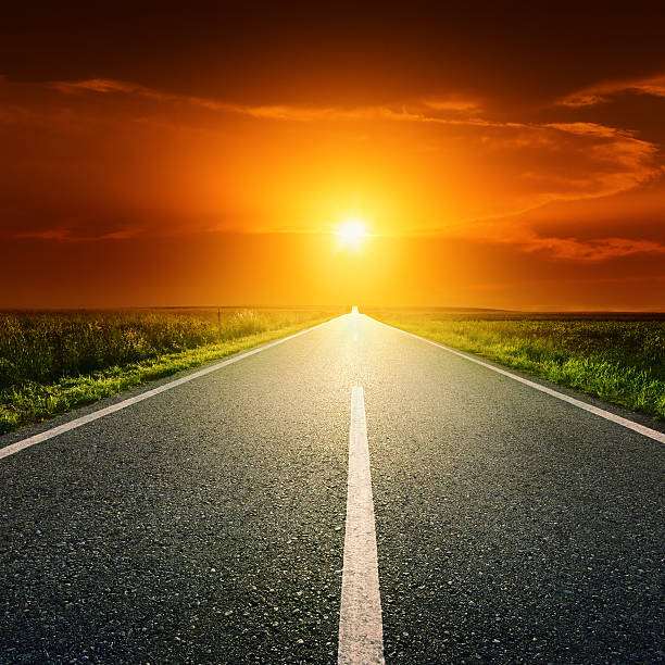 istock Driving on an empty country road at sunset 488891631