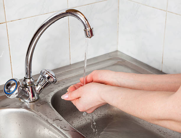 istock female hands under the running water 488893211