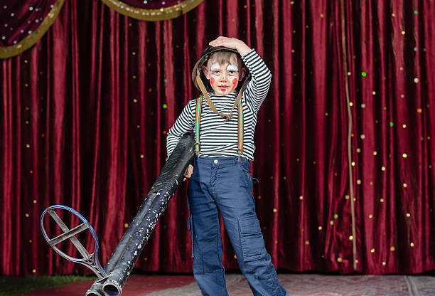 istock Young Boy Dressed as Clown Holding Oversized Rifle 488904700