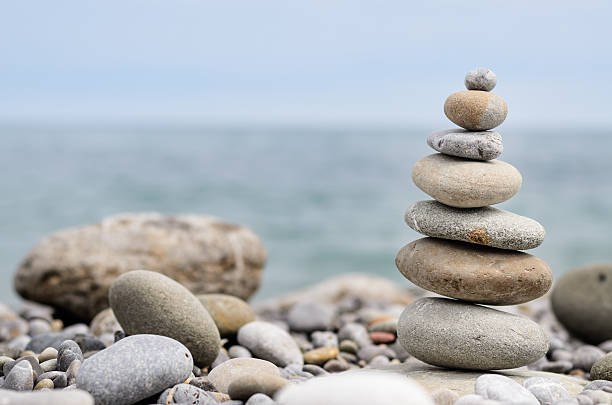 istock Round Smooth Stones Stacked on Rocky Beach 488905688