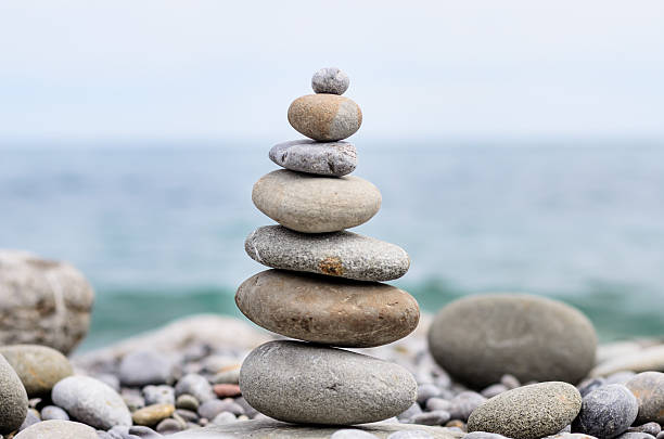 istock Round Smooth Stones Stacked on Rocky Beach 488905702