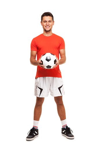 Soccer ball in hand of goalkeeper isolated on white background at studio.  Soccer player training or football match.