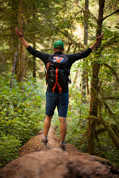 istock Victorious man crosses fallen log at Columbia River Gorge 488907586