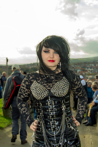 Whitby, UK - November 1, 2014: Whitby Goth Weekend, often abbreviated to WGW or simply referred to by attendees as Whitby, is a twice-yearly music festival for goths, in Whitby, North Yorkshire, England, organised by Jo Hampshire who runs Top Mum Promotions.  Goths in full dress at St Mary's Church 