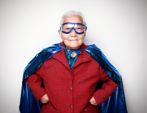 Portrait of an anonymous man, hacker wearing black suit and mask over white background with clipping path.