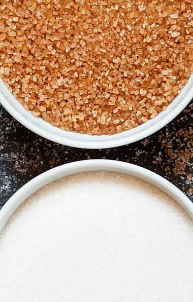 istock Cane and white sugar in a porcelain bowl, top view 488908488