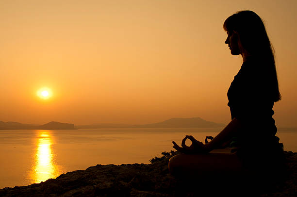 istock Yoga lotus position at sunrise 488910062