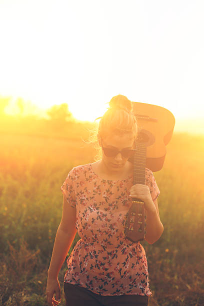 istock Holding guitar on the road 488910064