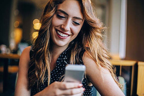 istock Young woman texting on smart phone 488910402