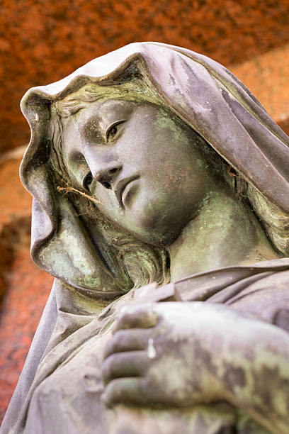 istock bronze sculpture of maria with red background 488910735