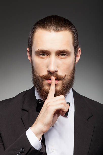 istock Cheerful young businessman with beard is gesturing 488911240
