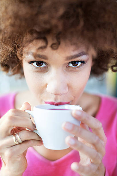 istock Afro woman with cup of tea 488911393