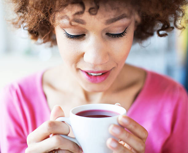 istock Afro woman with cup of tea 488911395