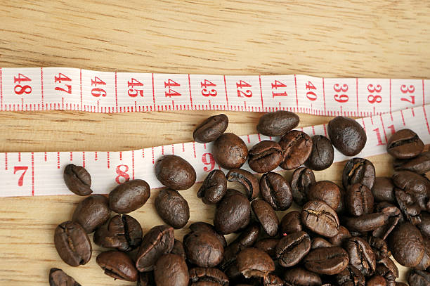 istock Coffee beans with measuring tape (diet concept) 488911449