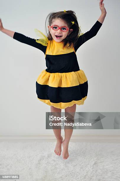 Girl With Glasses Like A Bee Jumping Stock Photo - Download Image Now - Bee Costume, Child, Bee