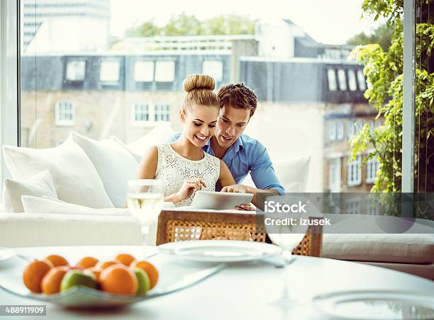 Couple With Digital Tablet Stock Photo - Download Image Now - Luxury, Lifestyles, Home Interior
