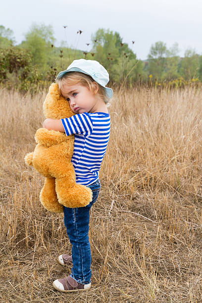 istock Cute little girl hugging a big Teddy bear 488912006