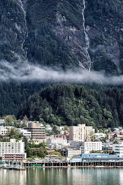 Downtown Juneau and waterfront, Alaska. Early morning. Waterfalls and fog nestled in the mountains.