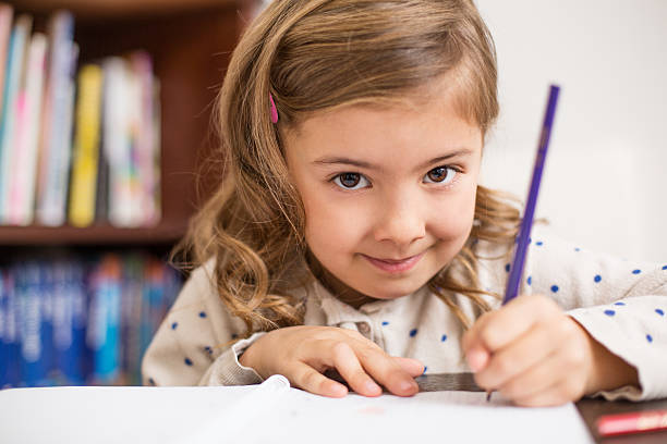 istock Young girl drawing with a pencil 488912347