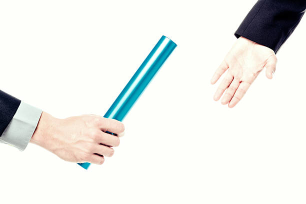 istock business people passing relay baton 488913185