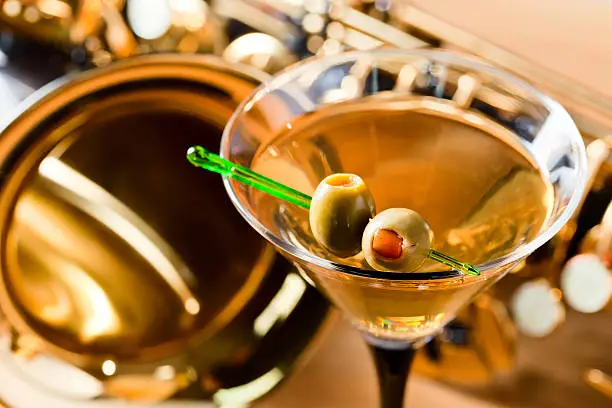 Photo of saxophone and martini with green olives