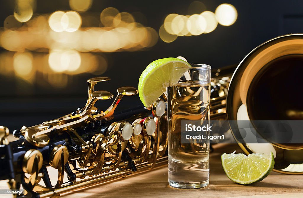 saxophone and tequila with lime saxophone and tequila with lime on wooden table Jazz Music Stock Photo