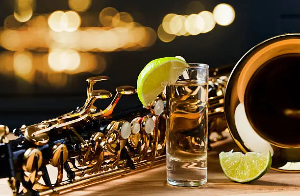 Photo of saxophone and tequila with lime