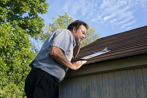 istock Insurance Adjuster On Cell Phone Looking For Hail Damage 488913998