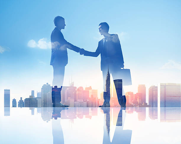 istock Silhouettes of Two Businessmen Having Handshake 488914639