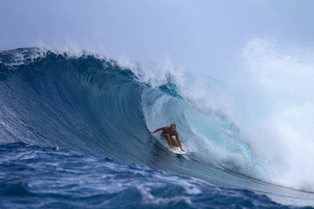 istock Surfer girl in a big backhand barrel 488915752