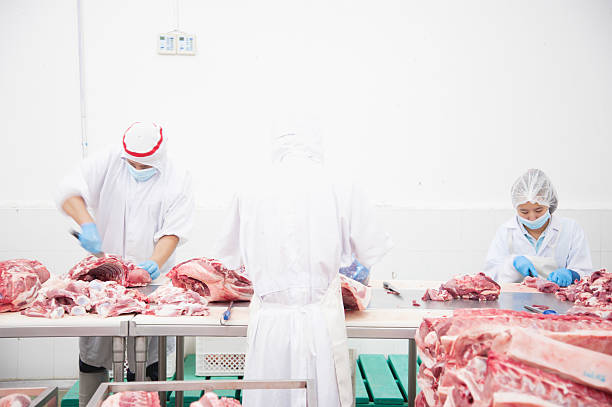 istock butcher cutting meat on the table 488916796