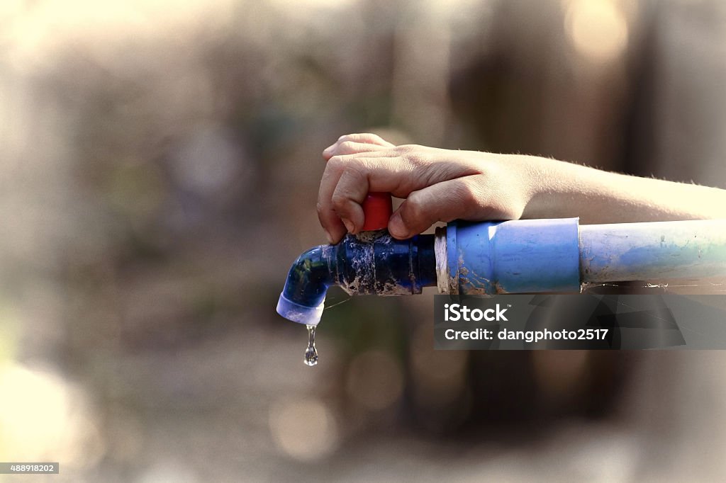 hand hold outdoor water tap with tube 2015 Stock Photo