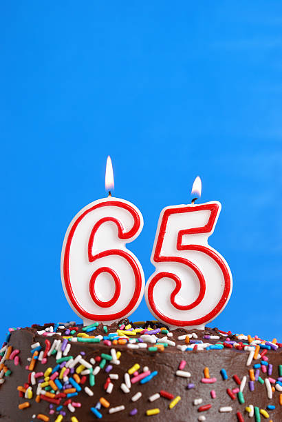 Celebrating Sixty Five Years A number candle is lit in celebration of sixty five years. 65 stock pictures, royalty-free photos & images