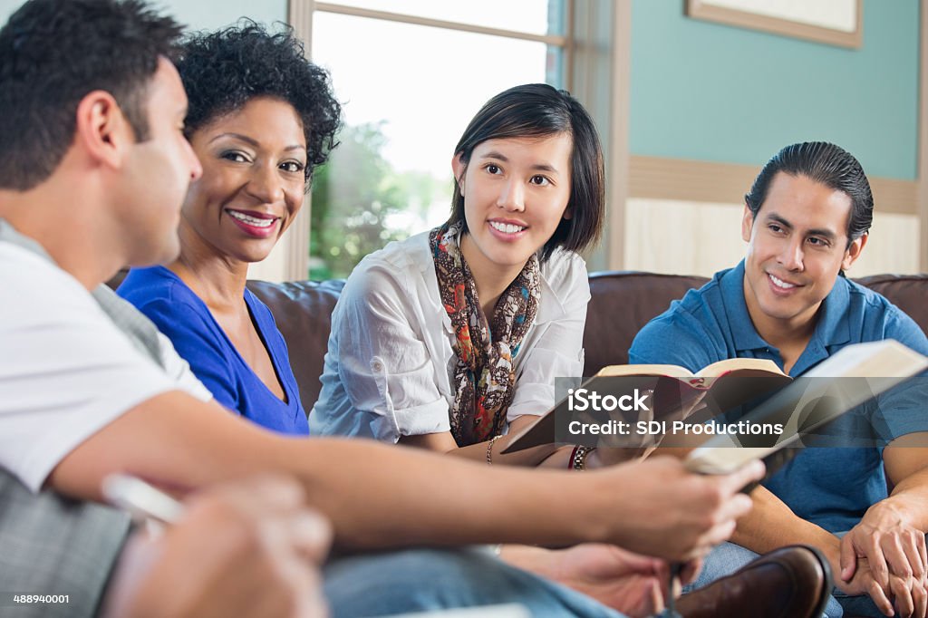 Group of young adults having discussion during bible study Bible Stock Photo