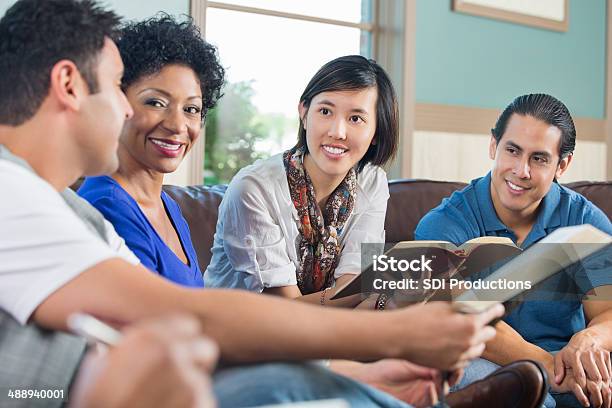 Group Of Young Adults Having Discussion During Bible Study Stock Photo - Download Image Now