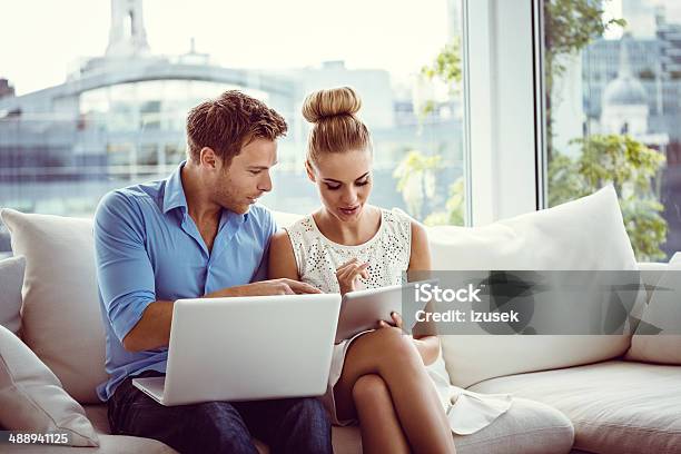 Couple With Technologies Stock Photo - Download Image Now - Luxury, Couple - Relationship, Laptop