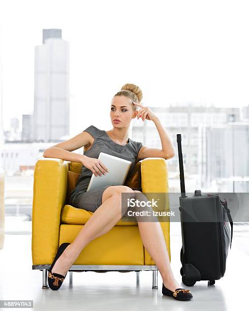 Businesswoman Waiting For A Meeting Stock Photo - Download Image Now - Sitting, Suitcase, 20-24 Years