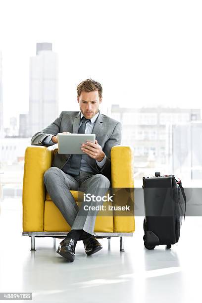 Businessman Waiting For A Meeting Stock Photo - Download Image Now - Businessman, Airport Departure Area, Using Digital Tablet