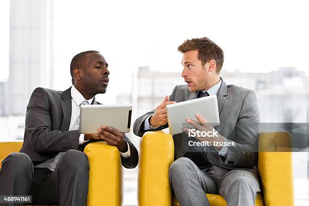 Two Businessmen With Digital Tablets Stock Photo - Download Image Now - Business, Business Meeting, Discussion